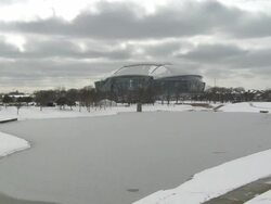 WS View over frozen pond at Super Bowl XLV with Cowboys Stadium / Arlington, Texas, United States Stock Footage