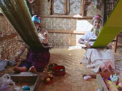 MS Shot of Two women wearing neck rings weaving next to each other / Inle Lake, Shan State, Myanmar  Stock Footage