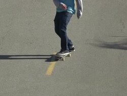 A young man skateboarding in the middle of the street. - Slow Motion Stock Footage