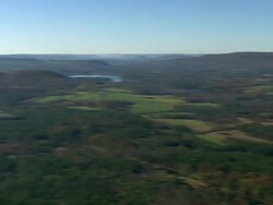 WS AERIAL PAN ZI Wooded area with autumn colors and small town nestling in trees / Massachusetts, United States Stock Footage