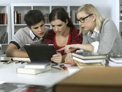 HD DOLLY: Students Using Digital Tablet In The Library Stock Footage