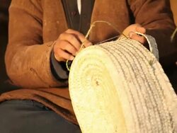 Tunisian Basket Maker weaves basket in traditional way Stock Footage