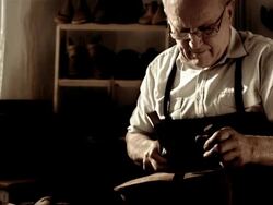 HD DOLLY: Shoemaker Fastening The Outsole Stock Footage