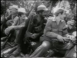 B/W 1959 group of guerrilla soldiers with guns sitting on ground outdoors / Cuba / newsreel Stock Footage