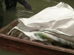 Transporting Sandbags In Small Boat News Clip
