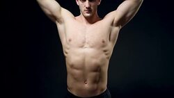 healthy athlete shows good muscle on black background Stock Footage