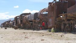 Girl on a swing at train cemetery at Salar de Uyuni Stock Footage