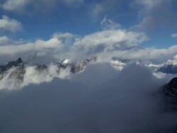 AERIAL CU  Clouds in blowing around to clear sky above  / Namche,Namche Valley,Nepal Stock Footage