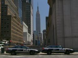 Two cop cars sit outside the post office with the Empire State building behind. Stock Footage