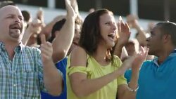 Stadium crowd cheers at sporting event, two men high-five Stock Footage