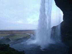 MS TU View of Seljalandsfoss Falls which large quantities of water falling in to basin of Falls from top of cliff / Iceland Stock Footage