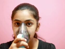 Indian teenager girl nebulizing herself medical treatment Stock Footage