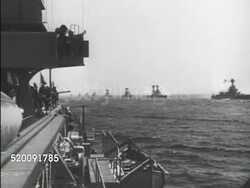 1934: UNITED STATES NAVY: *HA Angled WS US Warships in line on ocean, TU WS Flag w/ presidential seal. MS Unidentified admiral standing at railing w/ President Franklin D. Roosevelt. Instructional Video