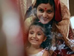Woman praying with her daughter in the temple  Stock Footage