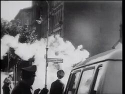 B/W 1961 smoke from smoke bomb rising on West Berlin street with soldiers / Germany / newsreel Stock Footage