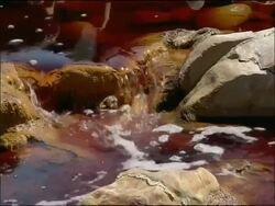 Water stained red by mineral ores (iron & other minerals very high pH), Rio Tinto, Huelva, Andalusia, Spain Stock Footage