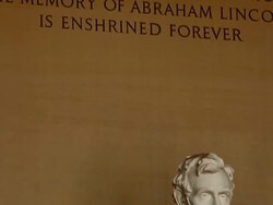 Tilt shot of dedication on Lincoln Memorial wall and Abraham Lincoln statue in Washington DC Stock Footage
