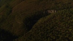 A river snakes through a densely wooded gorge. Stock Footage