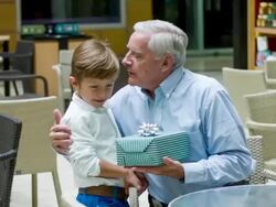 Grandson celebrating father's day with his grandfather Stock Footage