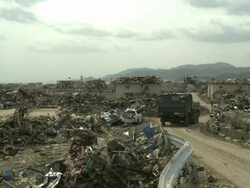 Destruction in Rikuzentakata, Iwate Prefecture, Japan on 2nd April 2011; after tsunami following Tohuku earthquake of March 2011.  This coastal town suffered severe damage with a large part of the residential area being completely flattened. Stock Footage