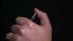 Woman clicking a biro pen News Clip