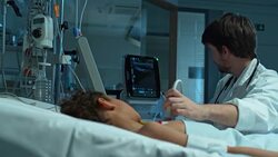 DS Doctor doing ultrasound on little boy in ICU Stock Footage