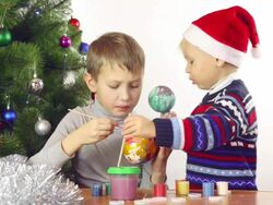 boys paints Christmas balls Stock Footage