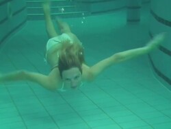 Blond girl swimming underwater Stock Footage