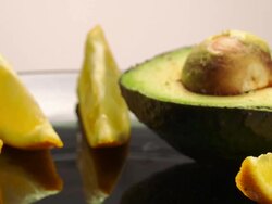 MS Hand placing avocado half next to other avocado / Los Angeles, California, United States Stock Footage