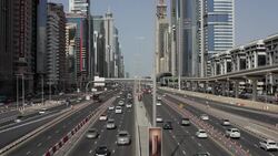 Commuter traffic uses Sheikh Zayed Road which is lined by the MTR elevated railway and skyscrapers in downtown Dubai. Stock Footage