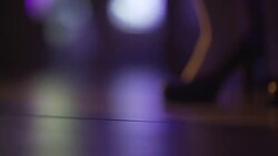 Close up of dancing women and men's feet on the dance floor at the night club or discotheque. Crowd women with beautiful legs in high heels dancing. Stock Footage