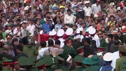 Tens of thousands pay last respects as war hero is buried in hometown News Clip