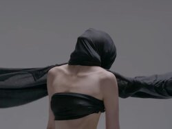 Unidentifiable woman yelling through black flowing cloth Stock Footage