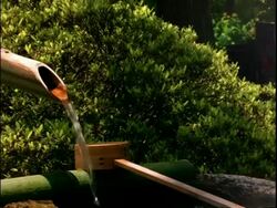 Bamboo water feature in garden of Sanzen-In Temple, Ohara, Kyoto, Japan Stock Footage