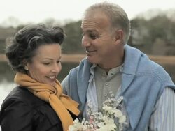 Loving mature couple by lake Stock Footage