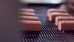 Candy poured by chocolate on production line. Food production line. Chocolate desserts on conveyor belt at chocolate factory. Food factory. Food processing plant. Chocolate factory Stock Footage