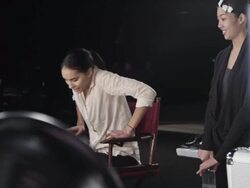 MS Female fashion models backstage at fashion show sitting in make-up chair Stock Footage