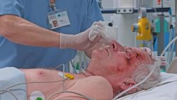 Nurse giving senior ICU patient a bath with cloth Stock Footage