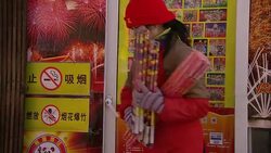 A vendor stacks fireworks outside a Panda Shop in Beijing, China. Stock Footage
