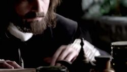 Nostradamus picks up a jar and compares it to something in a book. Stock Footage