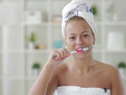 young woman brushing her teeth Stock Footage