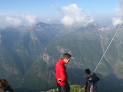 Hiking couple take pictures from mountain summit, besides others Stock Footage