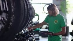 Employee checks price tags on new bikes in stock and enters data on tablet computer Stock Footage