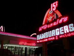 Night shot of the original "Speedee" road sign and famous Golden Arches at the McDonald's #1 Store Museum. Stock Footage