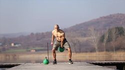 Doing exercise with kettle Stock Footage