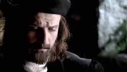 Nostradamus unrolls a parchment and reads it by candlelight. Stock Footage