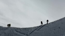 Climbers on the arete leading up from the Vallee Blanche to the Aiguille Du Midi above Chamonix, France Stock Footage