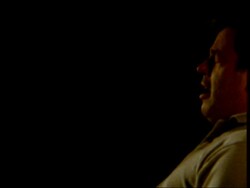 High Speed - MCU side view of man sneezing, black background Stock Footage