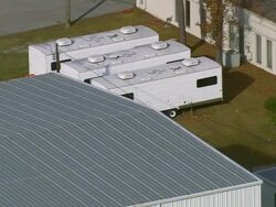 MS AERIAL Shot of three travelling container houses at Screen Gems Studio company / North Carolina, United States Stock Footage