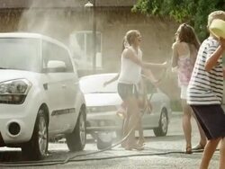 Slow motion medium shot of people having water fight / Pleasant Grove, Utah, United States Stock Footage